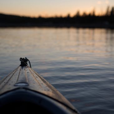 Kayak on a calm lake at dusk